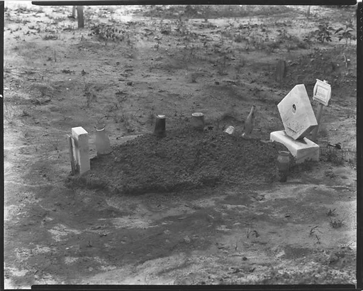 [Child's Grave with Bottles and Jars on Plot, Hale County, Alabama]