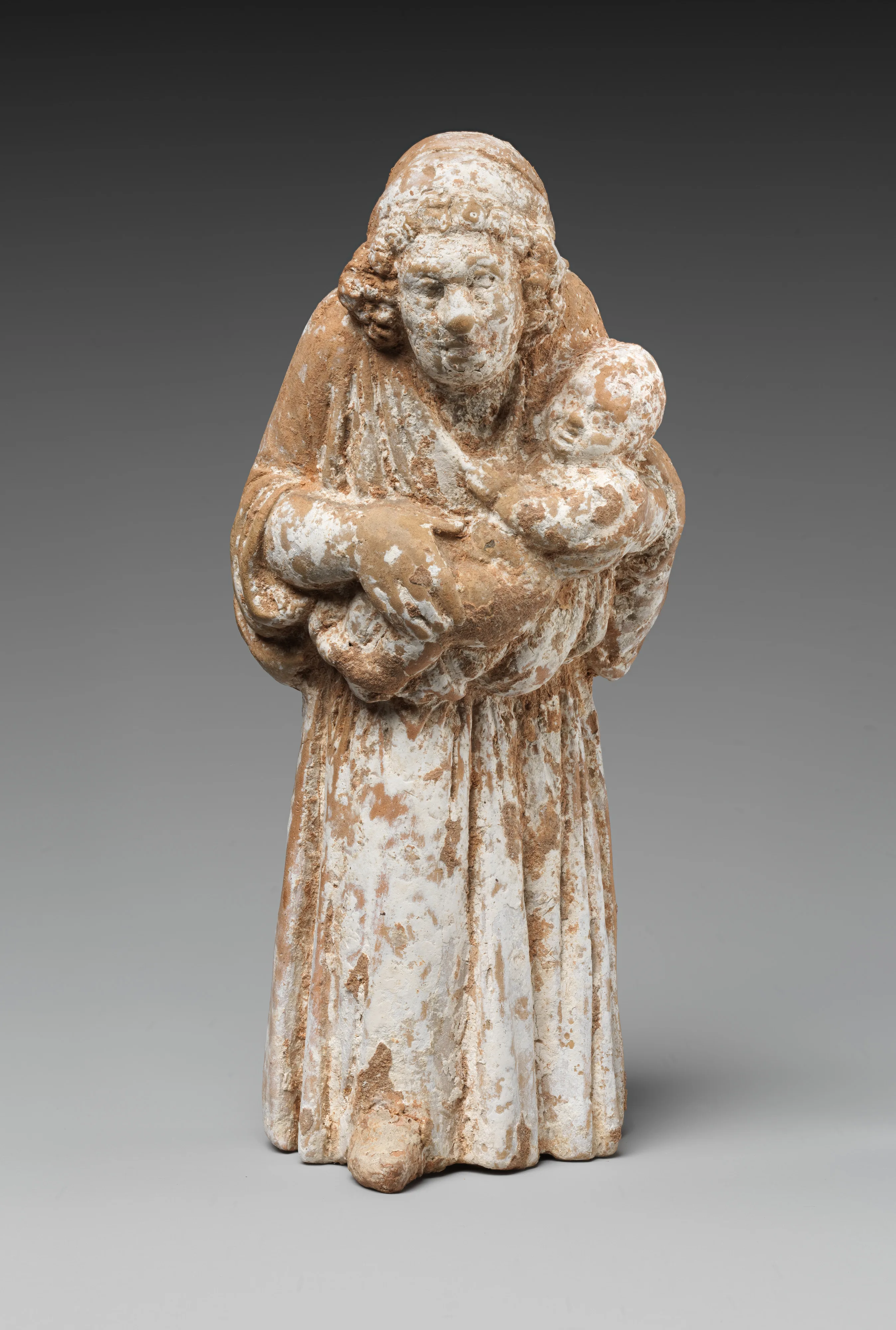 Terracotta statuette of a nurse carrying a child — Unknown