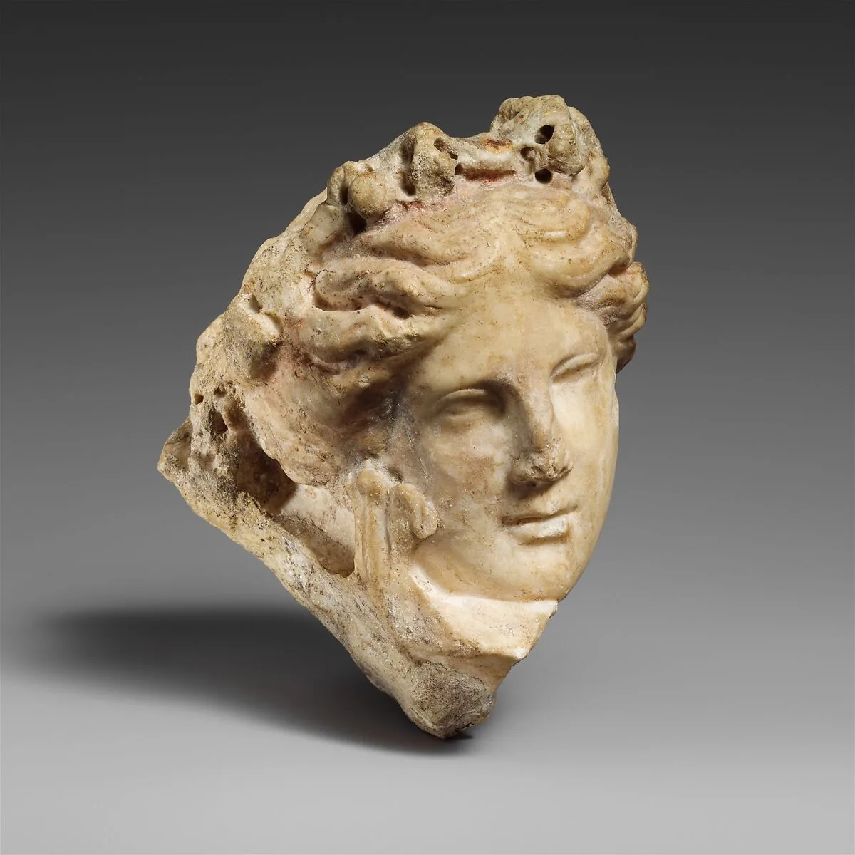 Marble head of a young woman, perhaps a muse — Unknown