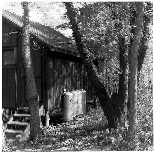 [Blurred View of Side of House with Four Tanks]