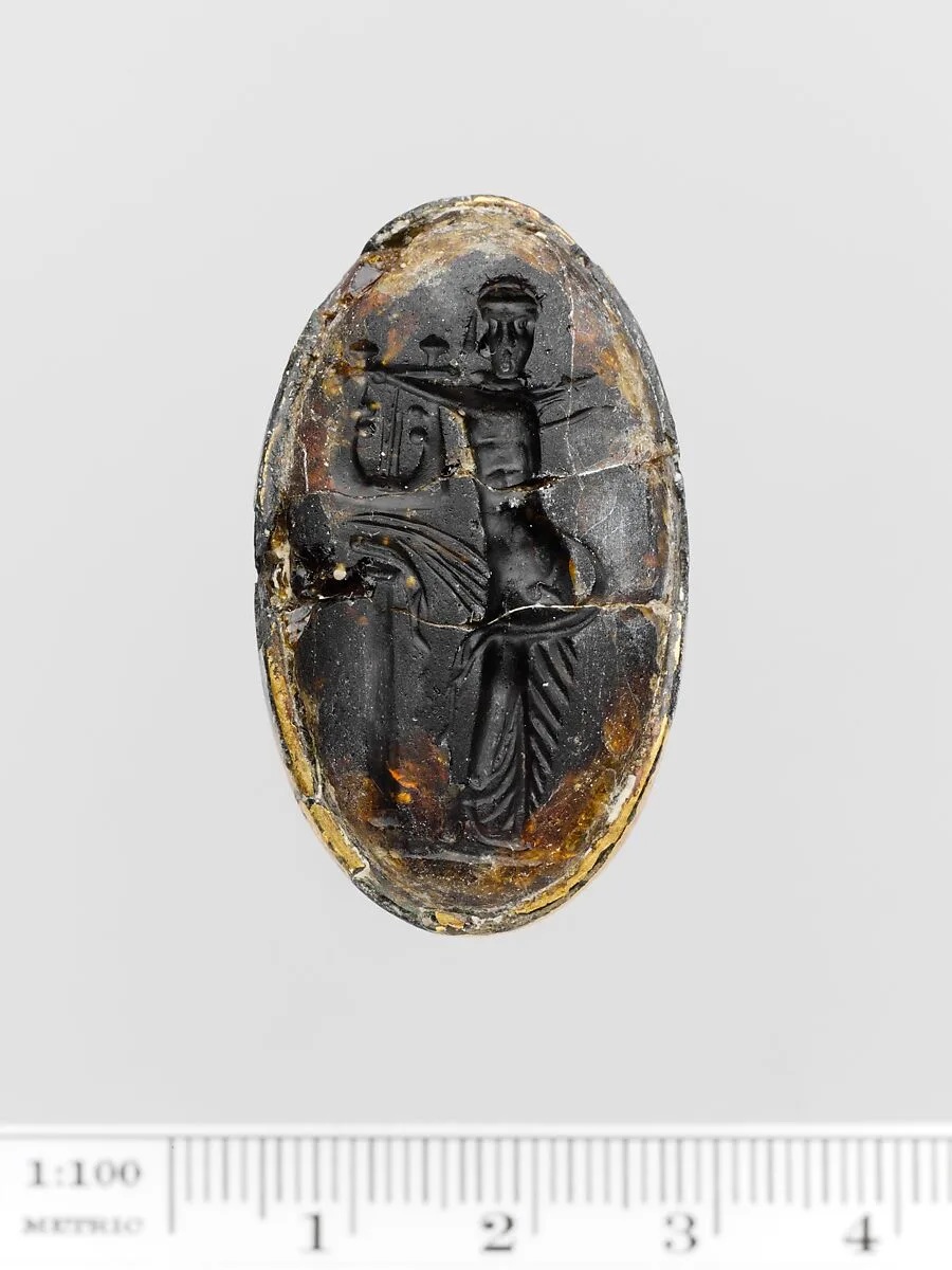 Brown glass oval set in a gilt bronze ring — Unknown