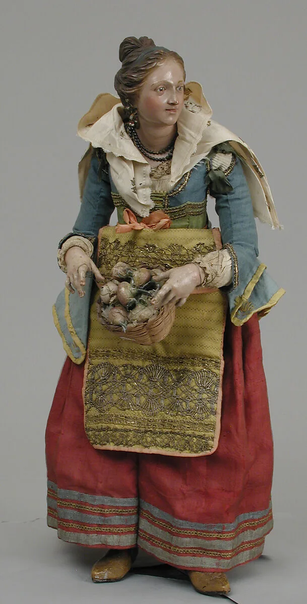 Girl carrying basket of onions — Unknown
