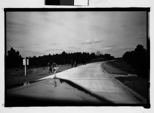 [People Walking by Side of Road, From Moving Automobile, Macon, Georgia]