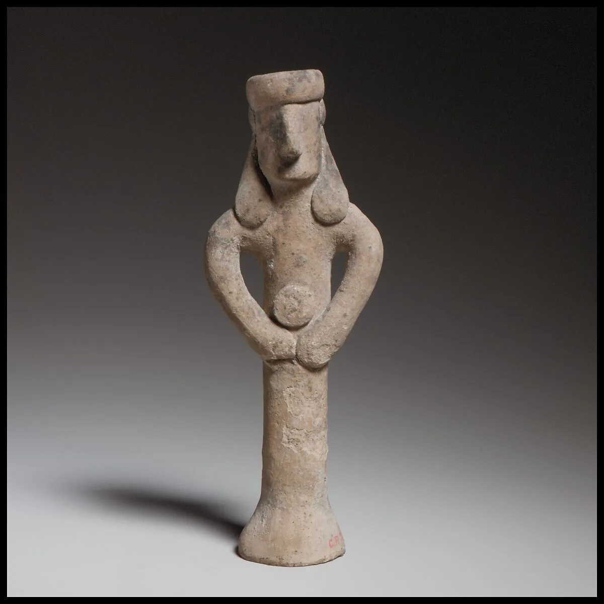 Standing figure holding a tambourine(?) — Unknown