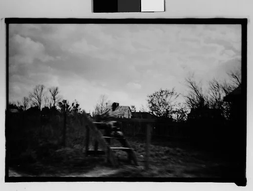 [Girl Seated on Roadside Platform, From Moving Automobile, New Orleans Vicinity, Louisiana]