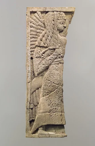 Furniture plaque carved in relief with standing woman