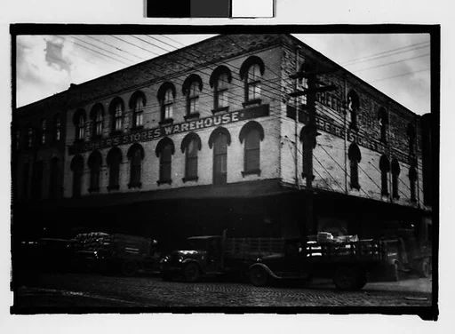 [Warehouse Building with Parked Trucks on Street, Mobile, Alabama]