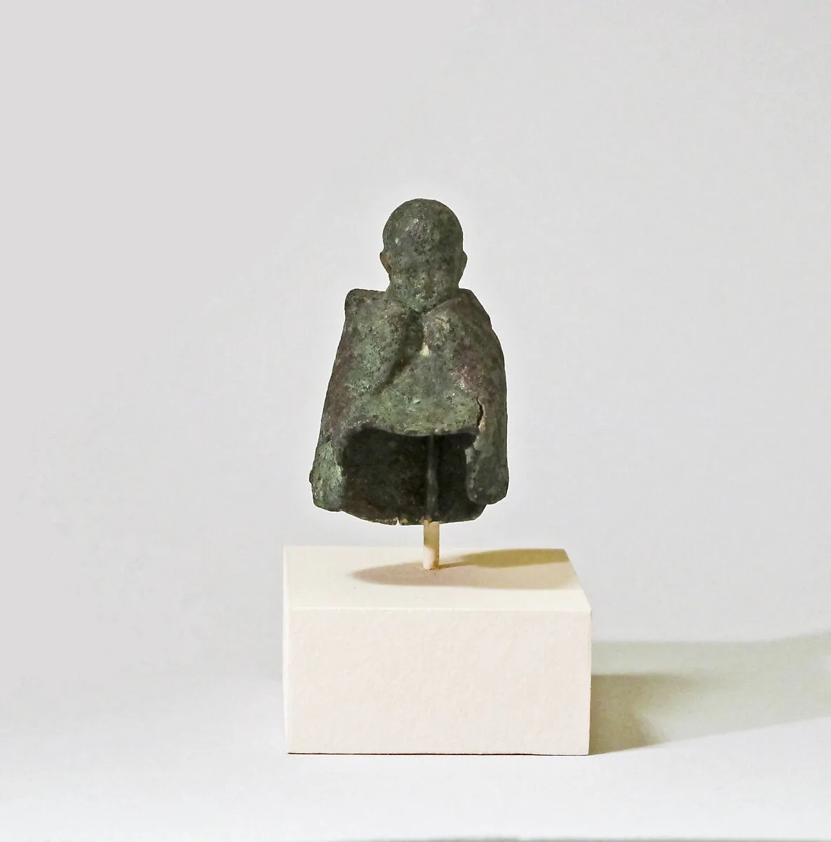 Fragmentary bronze statuette of boy wearing a mantle — Unknown