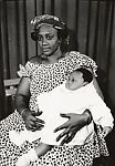 Woman holding an overdressed baby — Salla Casset
