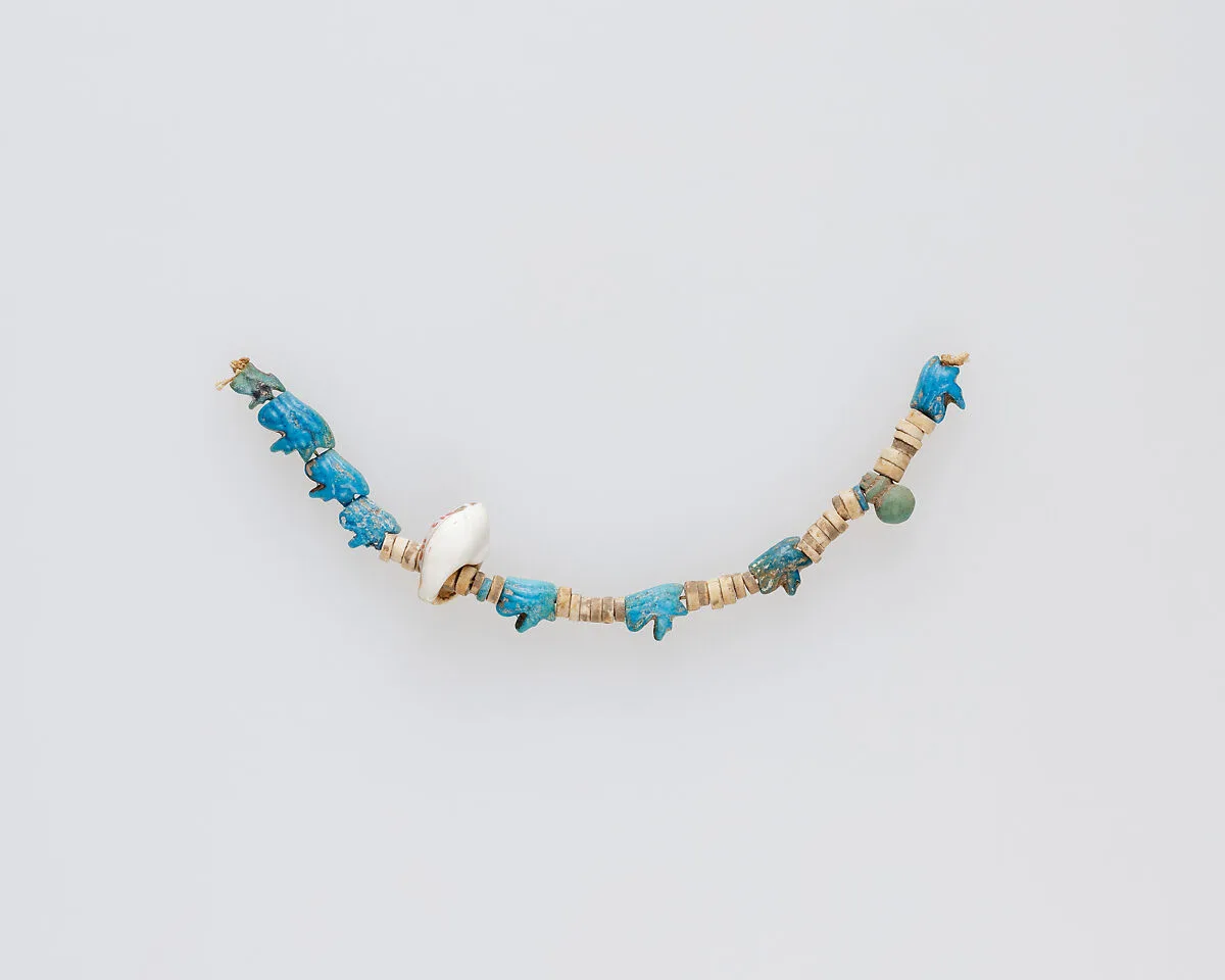 String of beads and amulets — Unknown