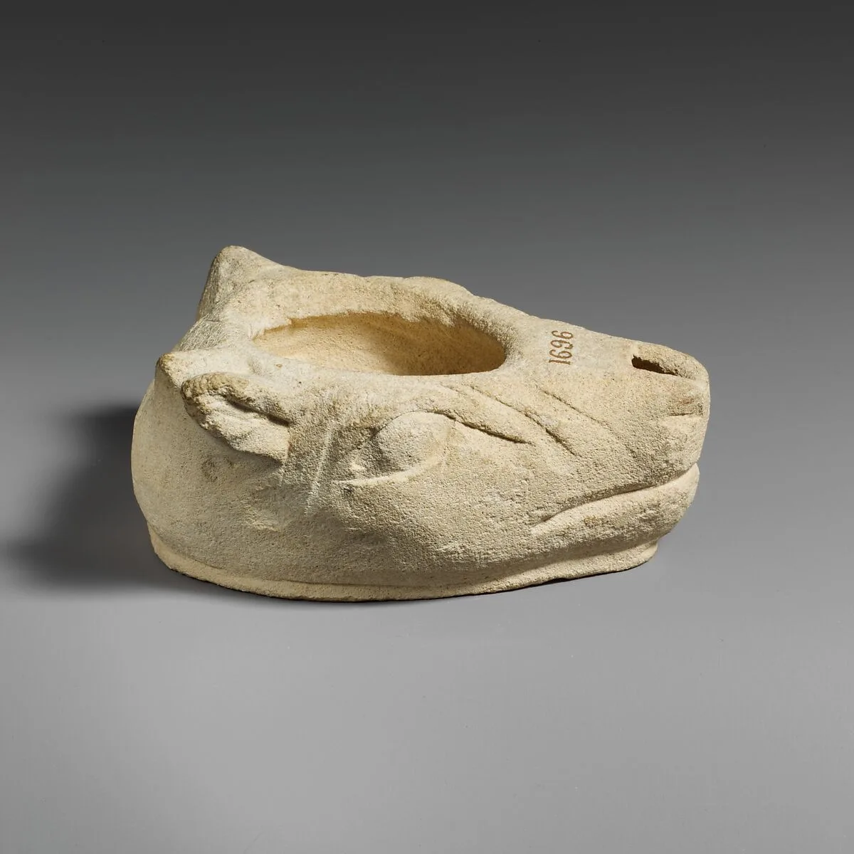 Limestone lamp in the shape of a bull’s head — Unknown