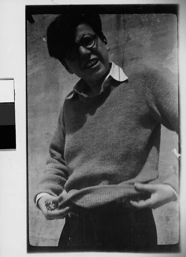 [Woman in Sweater and Horn-Rimmed Glasses]