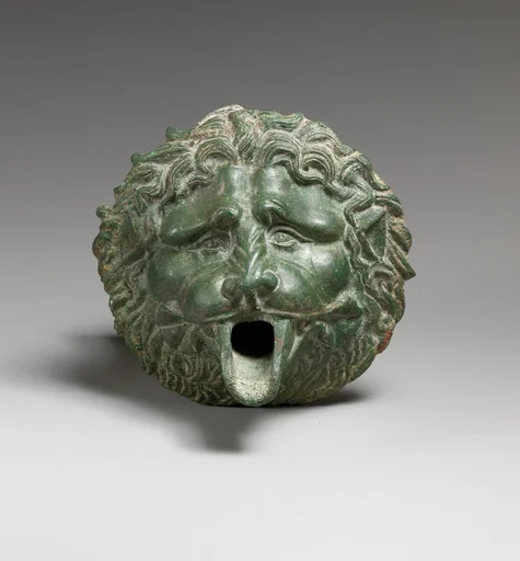 Bronze water spout in the form of a lion mask (one of a pair)