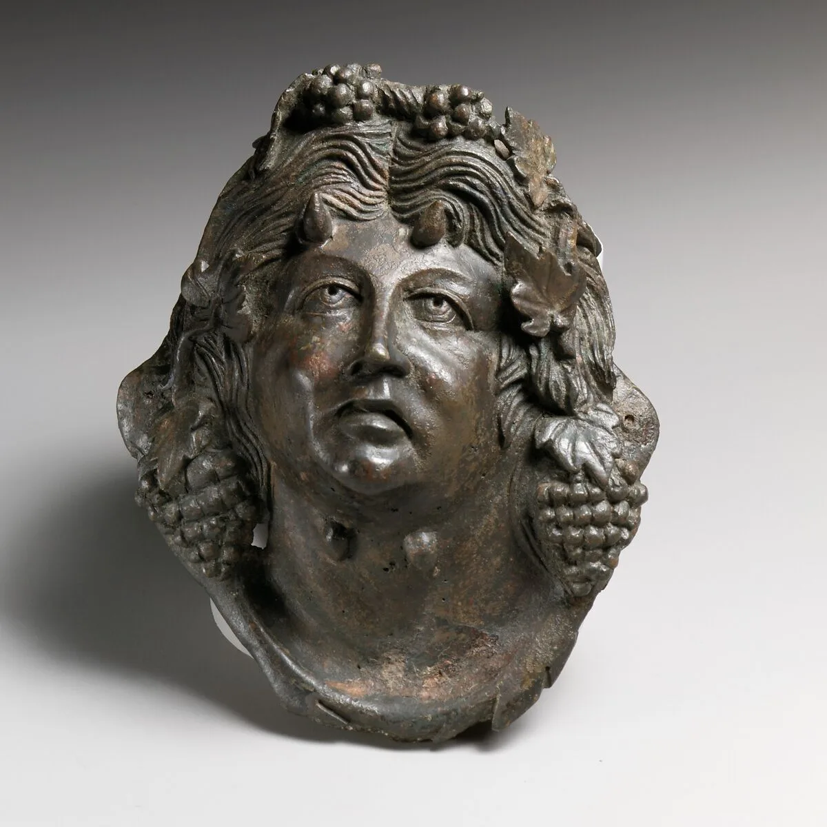 Bronze attachment in the form of the head of Pan — Unknown