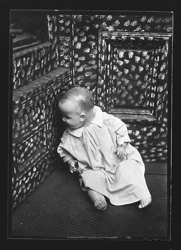 [Doll in Painted Doorway of Cutlery Shop, New York City]