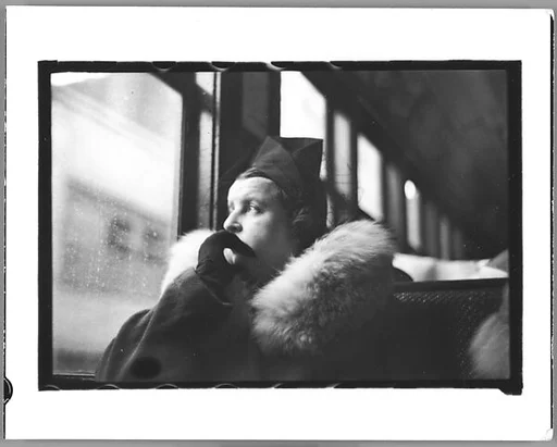 [Two 35mm Film Frames: Subway Passengers, New York City: Woman in Hat and Fur Collar Looking Out Window of Elevated Train; Helen Levitt Seated in Elevated Subway Car]