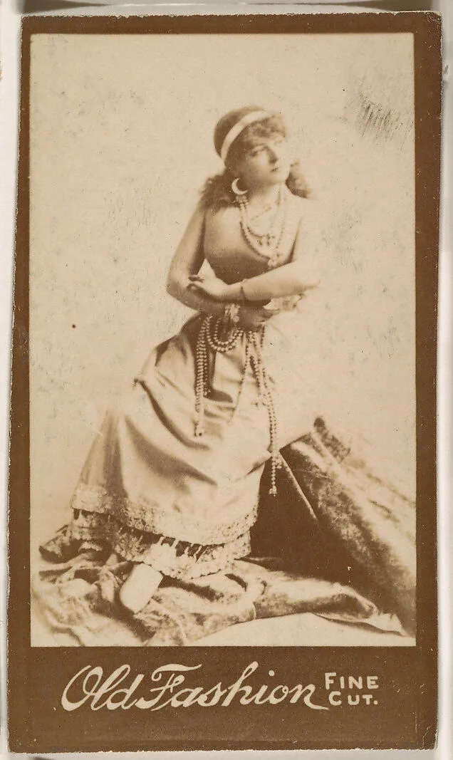Actress seated with arms folded, from the Actresses series (N664) promoting Old Fashion Fine Cut Tobacco — Unknown