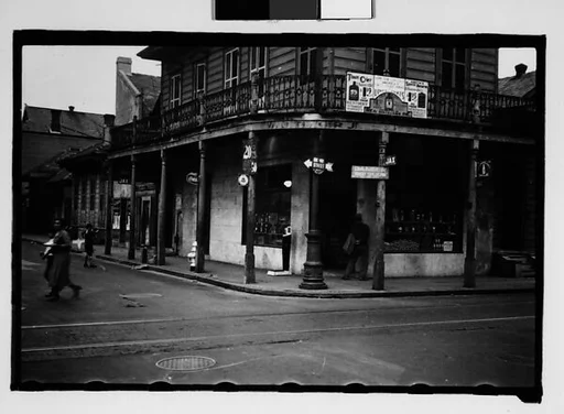 [Corner Grocery Store with Woman Crossing Street in French Quarter, New Orleans, Louisiana]