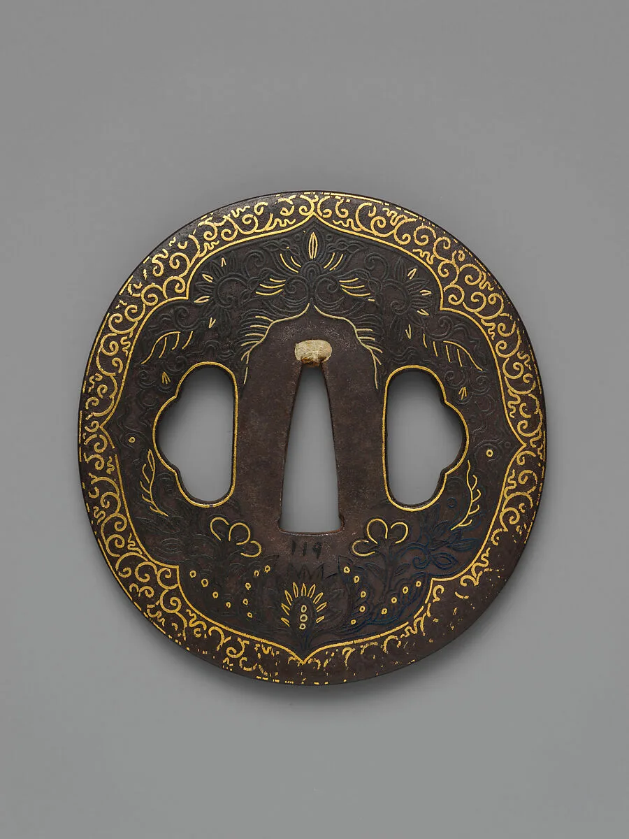 Sword Guard (<i>Tsuba</i>) Depicting Biting Lion Heads (<i>Shikami</i>) and Arabesques (獅噛唐草図南蛮鐔) — Unknown