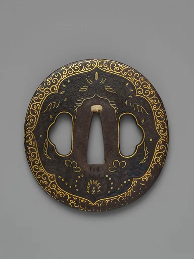 Sword Guard (<i>Tsuba</i>) Depicting Biting Lion Heads (<i>Shikami</i>) and Arabesques (獅噛唐草図南蛮鐔)