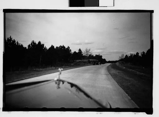 [People Walking by Road in Distance, From Moving Automobile, Macon, Georgia]