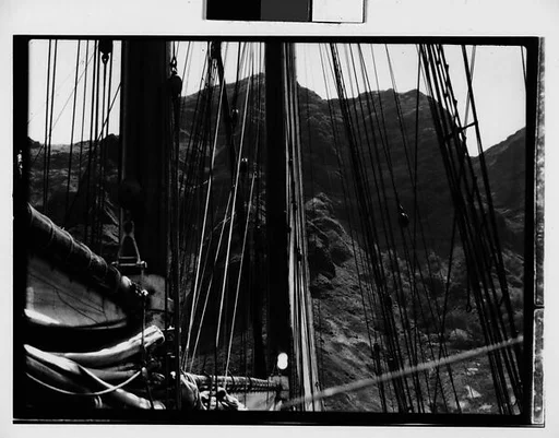 [South Seas: Mast and Rigging of Cressida in Front of Mountain Range]