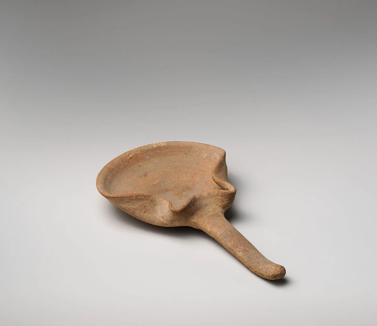 Terracotta handled saucer-shaped oil lamp — Unknown