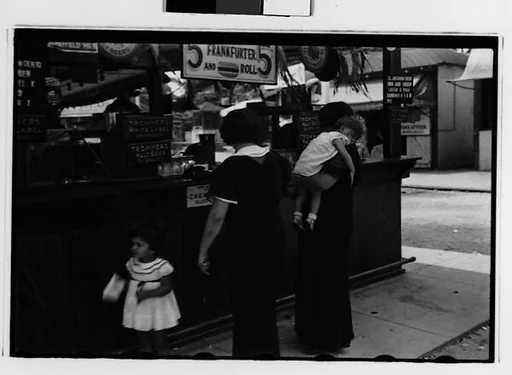 [Two 35mm Film Frames: Women and Children at Amusement Park Food Stand]