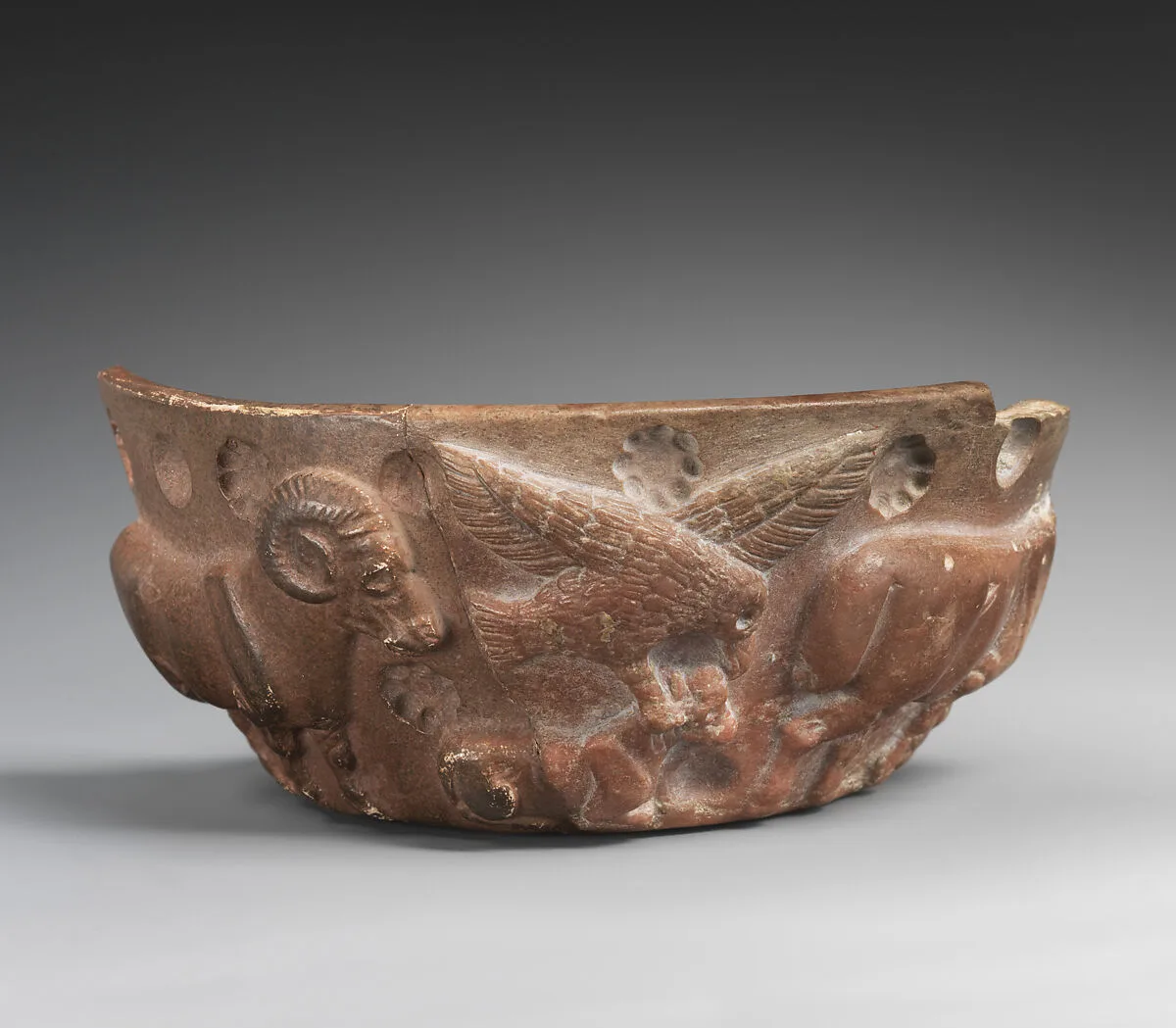 Fragment of a vessel with a bird of prey attacking a crouched animal in relief — Unknown