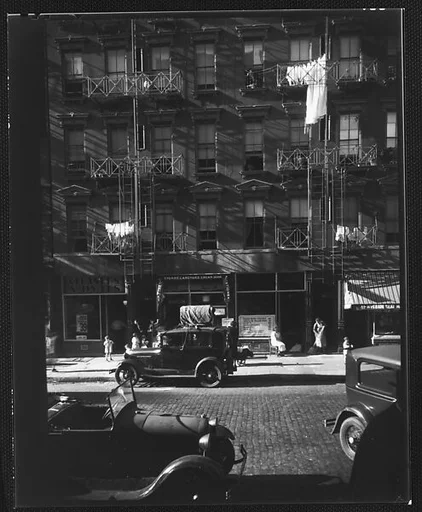 [Apartment Building with Ground Floor Shops and Parked Cars in Front, 41-43 Carmine Street, New York City]