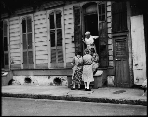 [Women Talking Outside Shuttered House, New Orleans, Louisiana]
