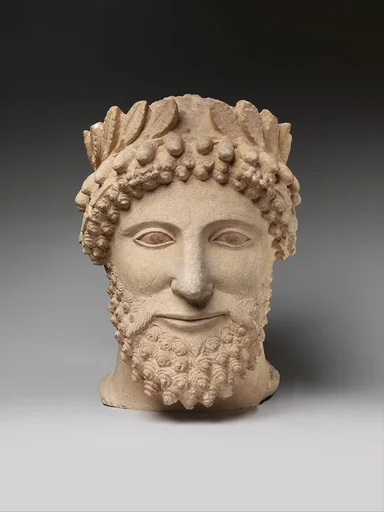 Limestone head of a bearded man wearing a wreath