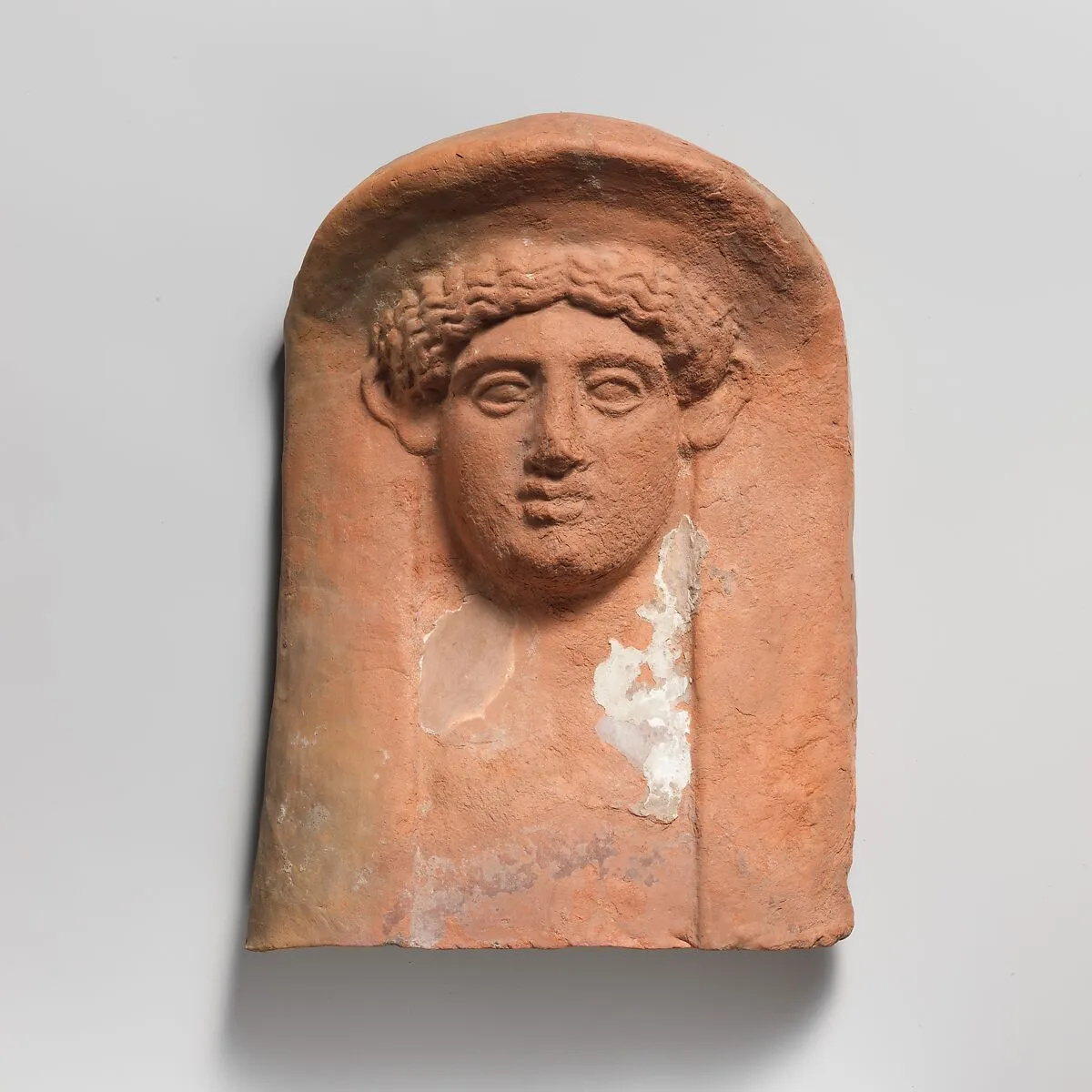Terracotta relief head of a woman — Unknown