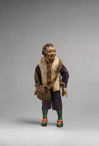 Small man with white furry vest, blue/purple suit, green painted leggings