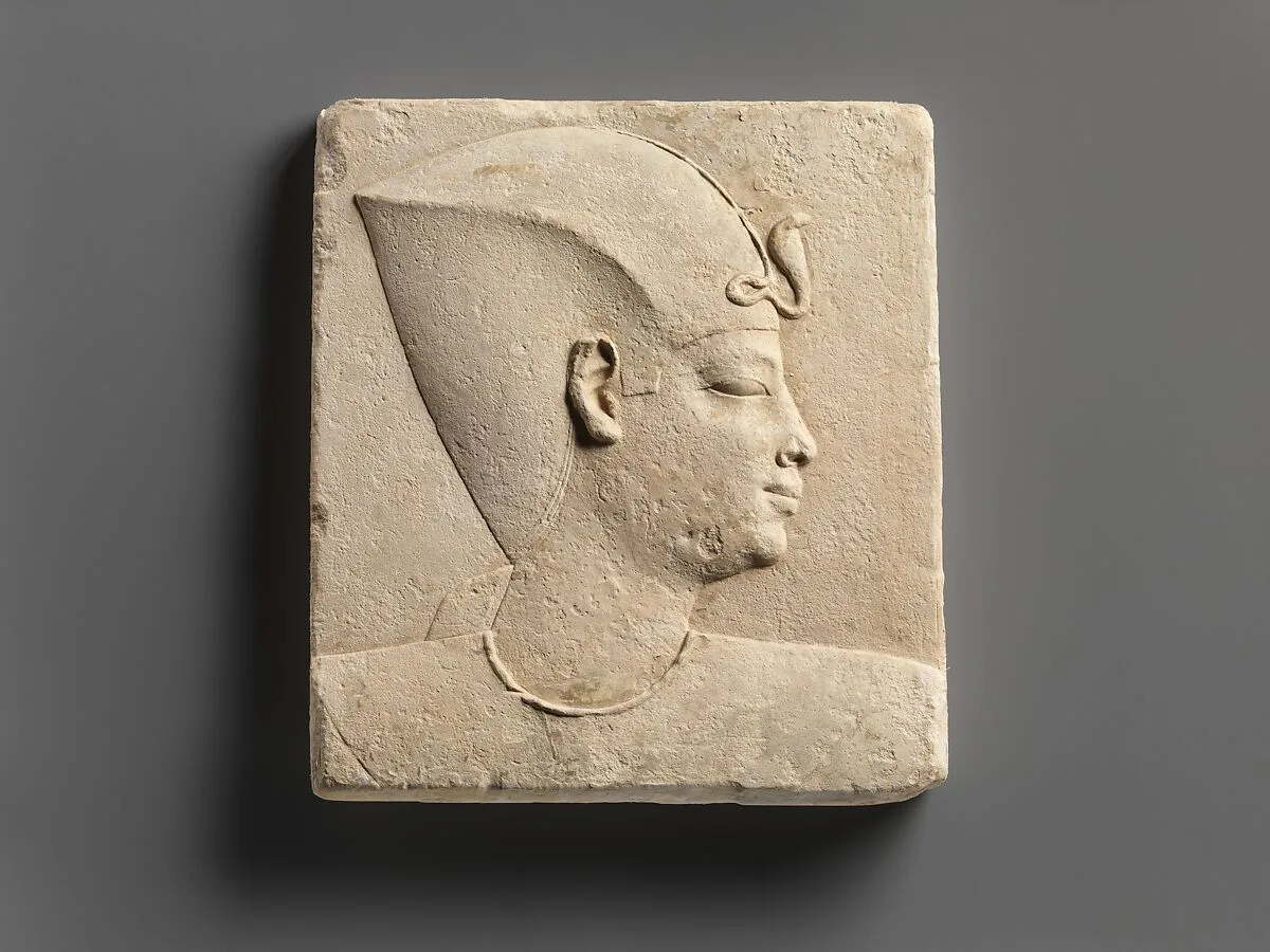 Relief of king's head in blue crown, head of child god on opposite side — Unknown