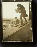 [Alfred Stieglitz Photographing on a Bridge]
