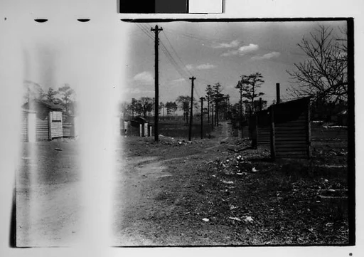 [Five 35mm Film Frames: Wooden Shacks on Dirt Road, Roadside Building with Painted Billboard of Franklin Delano Roosevelt on Roof, Southeastern U.S.]