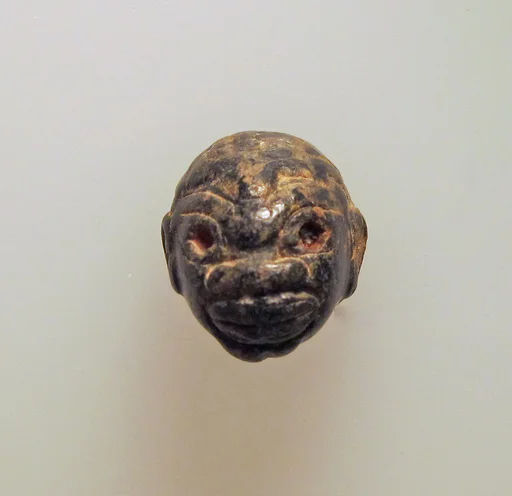 Chlorite pendant in the shape of a Black African's head
