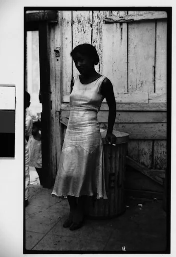 [Woman Leaning on Garbage Can in Courtyard, Havana]