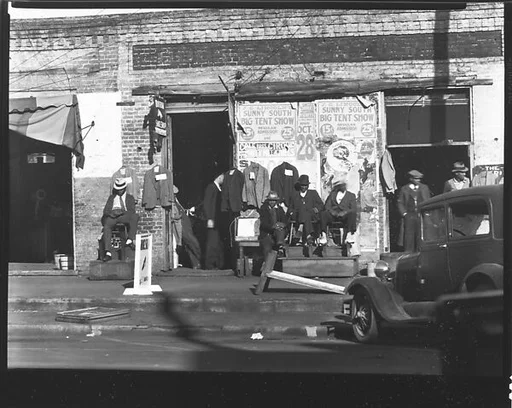 [Men Seated in Front of Boston Shoe Shop, Selma, Alabama]