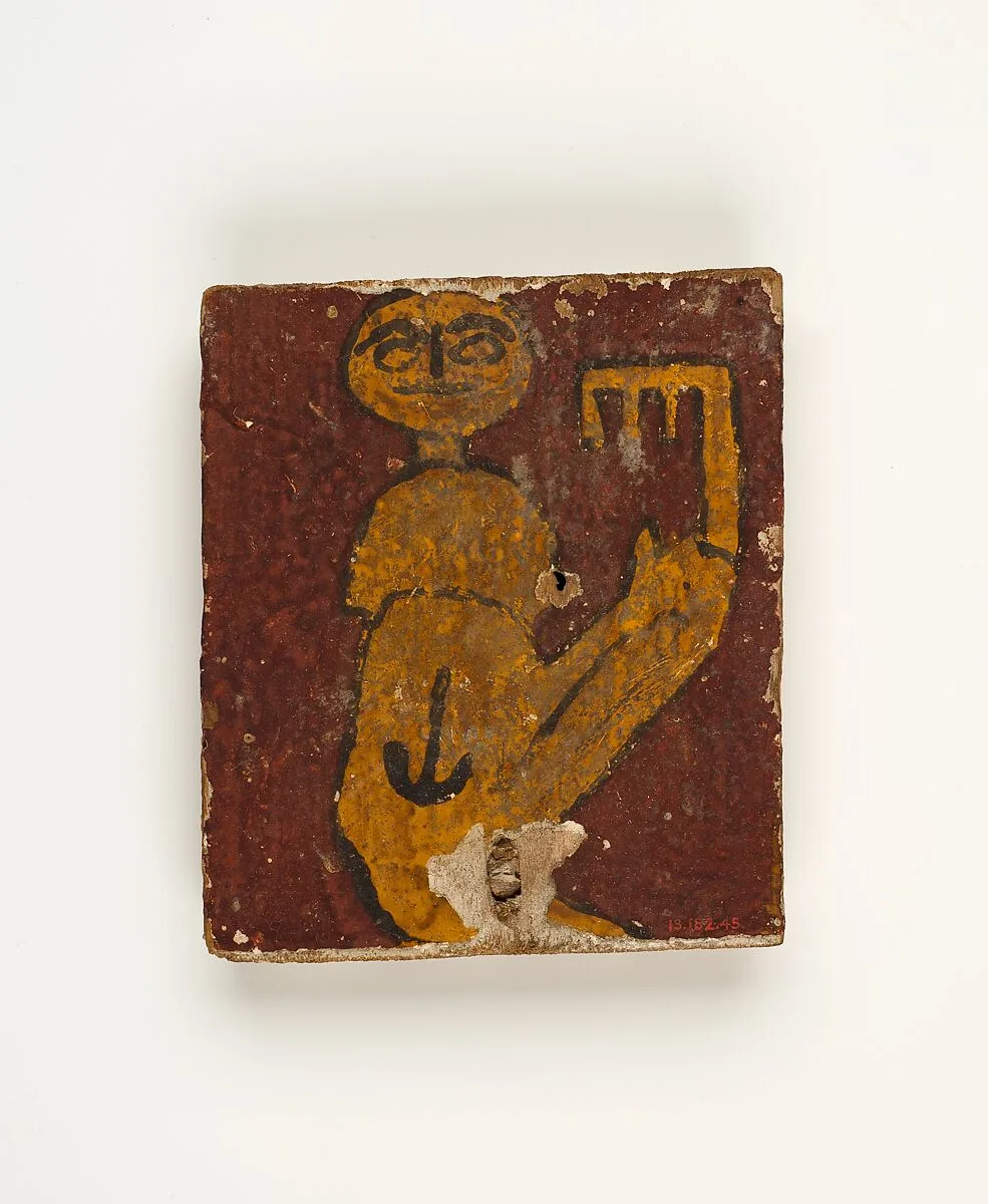 Panel with crouching figure holding a key — Unknown