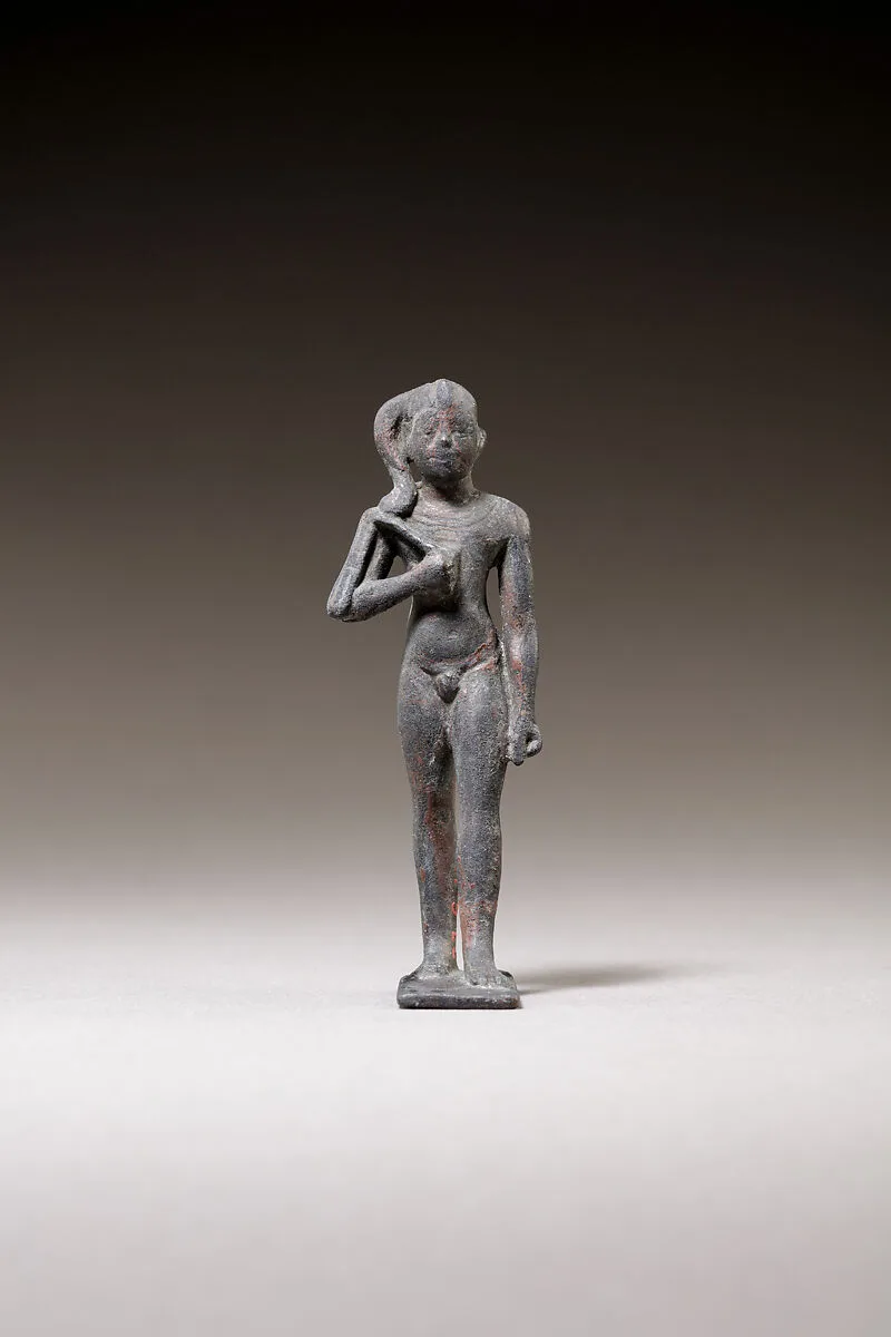 Child god standing and holding a flail — Unknown