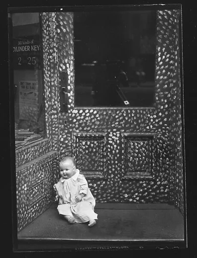 [Doll in Painted Doorway of Cutlery Shop, New York City]