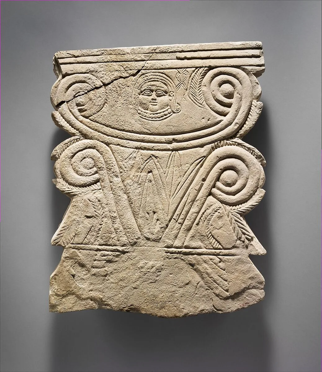 Limestone funerary stele with volutes and a Hathor head — Unknown