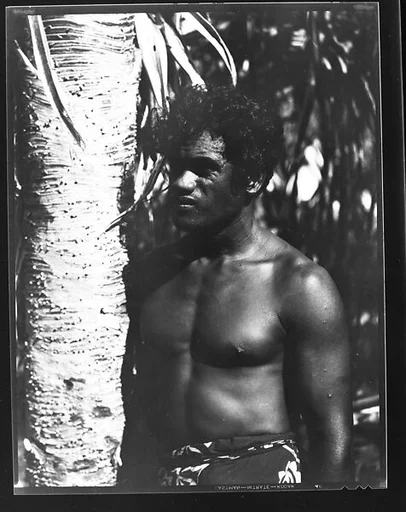 [South Seas: Man Wearing Sarong Next to Palm Tree]