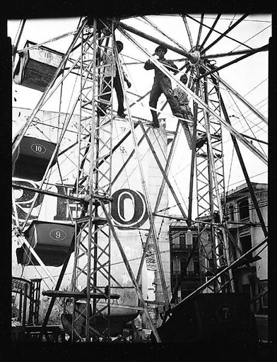 [Men Climbing on Ferris Wheel Spokes, Havana]
