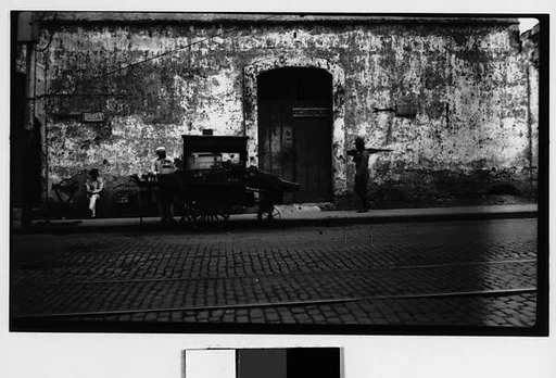 [Patrolling Officer and Vendor's Cart on Street, Havana]