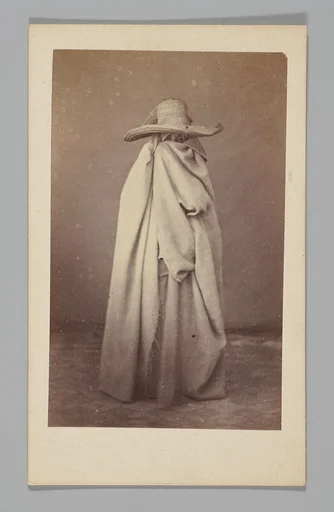 [Studio Portrait: Woman Wearing Robe and Straw Hat, Algeria]