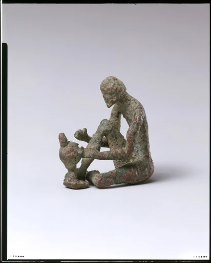 Bronze armorer working on a helmet