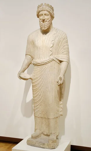 Limestone votary of a bearded male with a wreath
